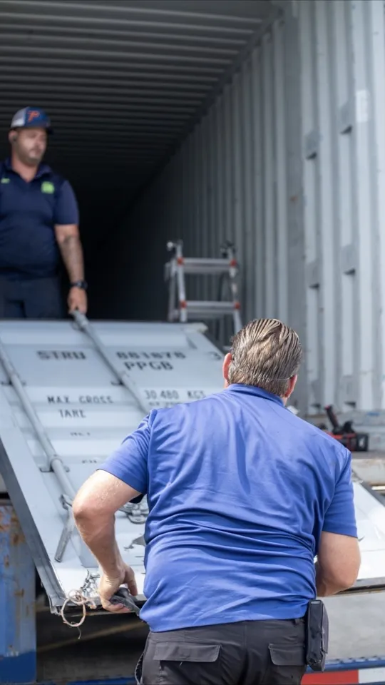 JTR crew handling a container door during a repair