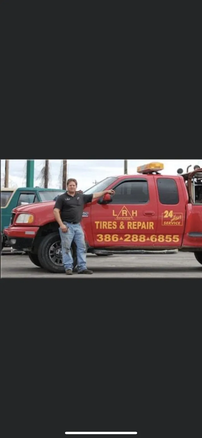 Jeff beside an early red company road service truck
